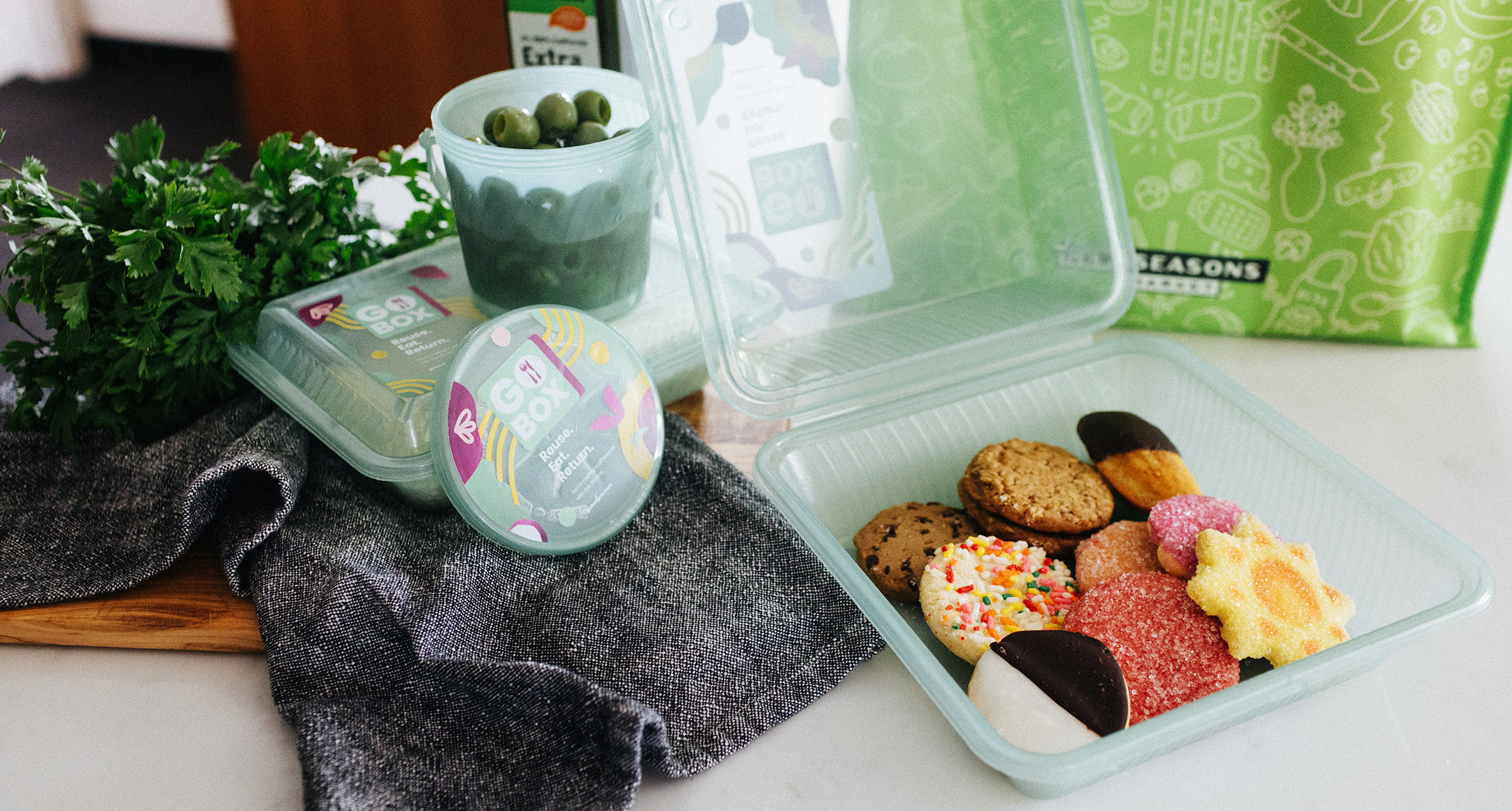 Green Bold Reuse containers filled with cookies and olives from New Seasons’ self-serve bars.