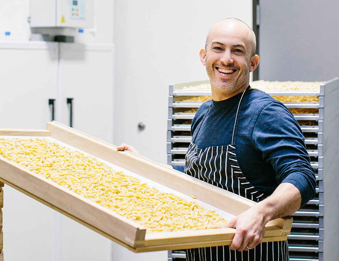 Adam Berger of Rallenti Pasta making pasta in a commercial kitchen.